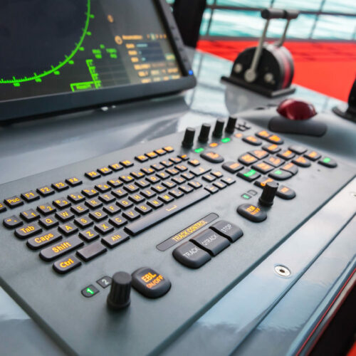 Modern ship control panel with radar screen, accelerator, trackball and keyboard