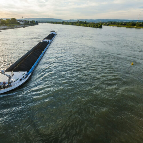 Cargo ship with coal bulk load on the river Rhine in Mainz, Germany